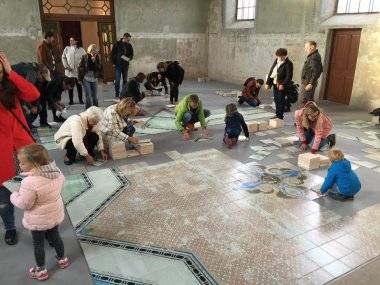 Desiatky ľudí skladajú v synagóge obrovské puzzle